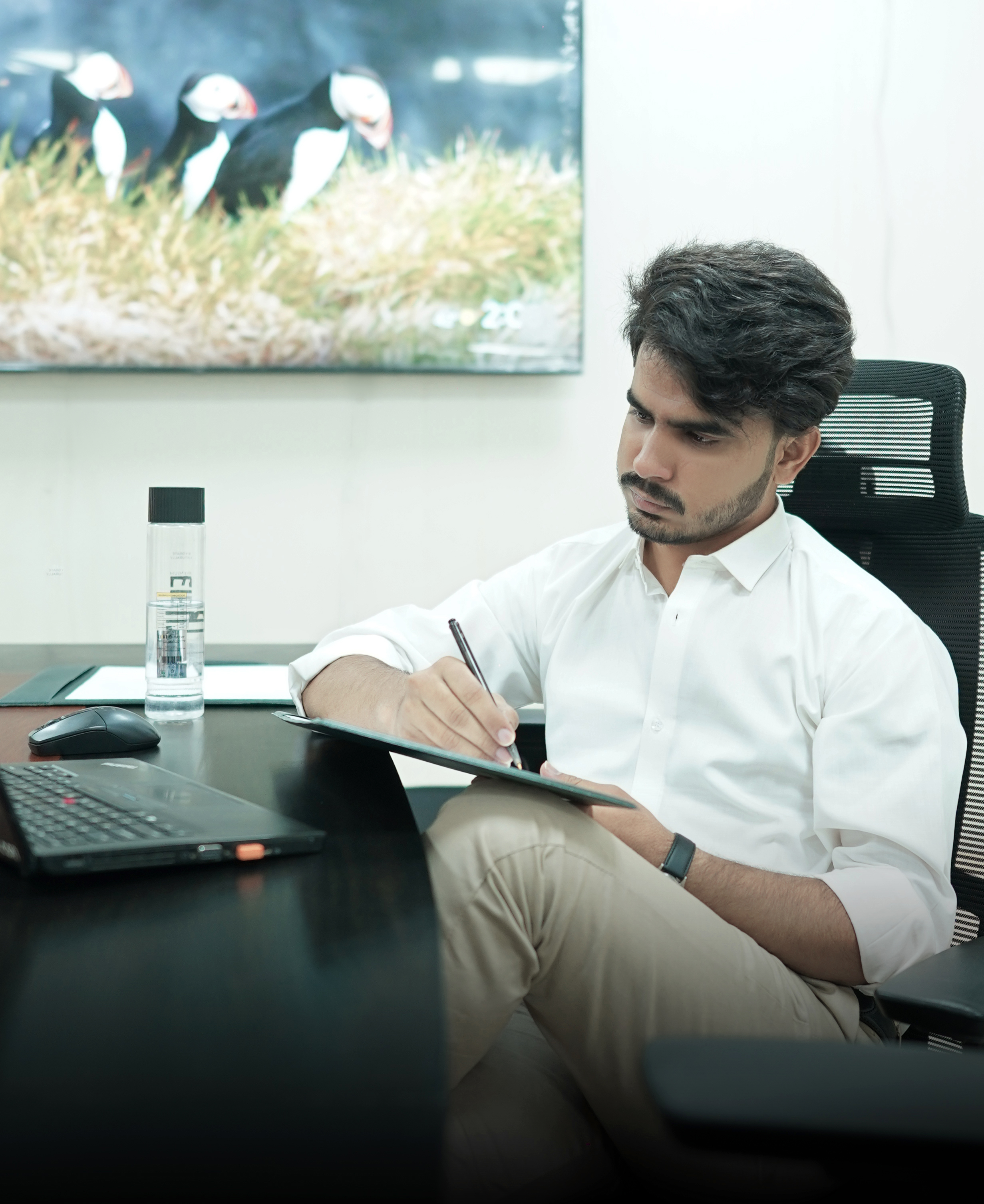 Uzair Saleem working at his desk
